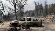 A car is seen burned as the Oak Fire burns near Jerseydale in Mariposa County, California, U.S. July 25, 2022. REUTERS/David Swanson