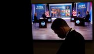 A White House press aide looks on as US President Joe Biden appears virtually in a meeting with business and labor leaders about the 'Chips Act' in an auditorium on the White House campus in Washington, US, July 25, 2022. (REUTERS/Jonathan Ernst)