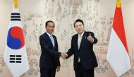 Indonesia's President Joko Widodo shakes hands with South Korea's President Yoon Suk-yeol at the Presidential Office in Seoul, South Korea, July 28, 2022. Yonhap via REUTERS