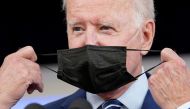 File Photo: US President Joe Biden removes his face mask prior to receiving his COVID-19 booster vaccination in the Eisenhower Executive Office Building's South Court Auditorium at the White House in Washington on September 27, 2021. (REUTERS/Kevin Lamarque)