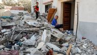 Hesham, one of four disabled Palestinian siblings from Shamalakh family, sits at the rubble of their home after it was destroyed in an Israeli air strike in Gaza City on August 6, 2022. (Reuters/Ibraheem Abu Mustafa)

