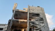 A Palestinian man walks through the ruins of a house at the scene where senior commander of Islamic Jihad militant group Khaled Mansour was killed in Israeli strikes, in Rafah in the southern Gaza Strip, August 7, 2022. REUTERS/Ibraheem Abu Mustafa