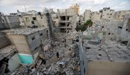 Palestinians gather on the rubble of houses in Rafah in the southern Gaza Strip on August 7, 2022. (REUTERS/Ibraheem Abu Mustafa)