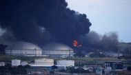 Fire is seen over fuel storage tanks that exploded near Cuba's supertanker port in Matanzas, Cuba, August 7, 2022. (REUTERS/Alexandre Meneghini)