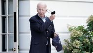 US President Joe Biden takes off his mask as he walks towards Marine One for departure to Rehoboth Beach, Delaware from the South Lawn of the White House in Washington on August 7, 2022. (REUTERS/Ken Cedeno)
