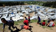 Syrian refugee children play together at a Syrian refugee camp in the Bekaa valley, Lebanon in 2020 [File: Ali Hashisho/Reuters] 