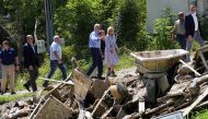 US President Joe Biden and first lady Jill Biden walks through debris while viewing flood damage and response efforts in Lost Creek, Kentucky, US, August 8, 2022. (REUTERS/Kevin Lamarque)