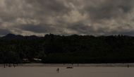 Villagers harvest edible seaweed, sea snails and other food sources during low tide next to Serua Village, Fiji, July 14, 2022. REUTERS/Loren Elliott

