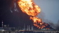 Fire is seen over fuel storage tanks that exploded near Cuba's supertanker port in Matanzas, Cuba, August 8, 2022. (REUTERS/Alexandre Meneghini)