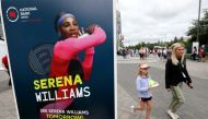 People pass a poster advertising the match of veteran tennis player Serena Williams outside a stadium at the National Bank Open in Toronto, Ontario, Canada August 9, 2022. Reuters/Chris Helgren