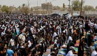 Supporters of Iraqi populist leader Moqtada al-Sadr gather for a Friday prayer in front of the parliament near the Green Zone, in Baghdad, Iraq, August 12, 2022. (REUTERS/Ahmed Saad)