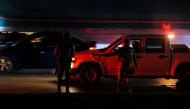Members of security forces stand along an avenue after vehicles were set on fire by unidentified individuals in Tijuana, Baja California state, Mexico, August 12, 2022. (REUTERS/Jorge Duenes)