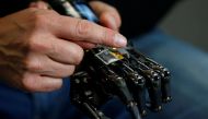 COVVI Group CEO Simon Pollard holds the bionic hand developed by COVVI, at Quayside Business Park, in Leeds, Britain August 11, 2022. REUTERS/Craig Brough