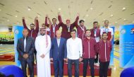 Qatar’s players and officials celebrate a silver medal yesterday. 