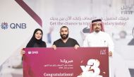 QNB officials awarding a winner of ‘Triple Your Salary’ campaign, in Doha, recently. 