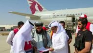 A file photo of Afghan officials receiving aid provided by Qatar as part of efforts to contain the humanitarian crisis in Afghanistan.