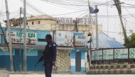 A Somali police officer stands near Hotel Hayat, the scene of an al Qaeda-linked al-Shabaab group militant attack in Mogadishu, Somalia August 20, 2022. Reuters/Feisal Omar