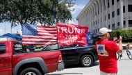A small caravan of vehicles with Trump flags drove past the court in West Palm Beach, Florida, as the hearing kicked off [Marco Bello/Reuters]