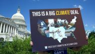 A volunteer holds a placard during a news conference on the climate crisis and the Inflation Reduction Act at the U.S. Capitol in Washington, D.C., U.S., August 12, 2022. REUTERS/Kevin Lamarque

