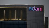The logo of the Adani Group is seen on the facade of one of its buildings on the outskirts of Ahmedabad, India, on April 13, 2021. REUTERS/Amit Dave/File Photo
