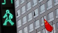 A Chinese national flag flutters outside the China Securities Regulatory Commission building on the Financial Street in Beijing, China, July 9, 2021. (REUTERS/Tingshu Wang)

