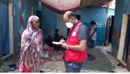 A QRCS representative interacting with a woman affected by flood in Mauritania.