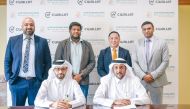Officials from CWallet and Al Dar For Exchange Works during the agreement signing ceremony. 