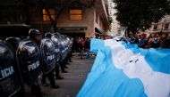 Supporters gather outside the house of Argentina's Vice President Cristina Fernandez de Kirchner as police officers hold their shields in Buenos Aires, Argentina, August 27, 2022. Reuters/Agustin Marcarian