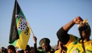 Supporters of the African National Congress hold the party flag during ANC campaign in Atteridgeville a township located to the west of Pretoria, South Africa July 5, 2016. REUTERS/Siphiwe Sibeko

