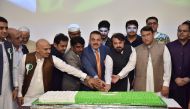 Officials cutting a cake to mark 75th Anniversary of Pakistan’s Independence Day during an event organised by Read Pakistan.