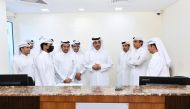 Minister of  Labour H E Dr. Ali bin Smaikh Al Marri (fourth right) and Qatar Chamber Chairman Sheikh Khalifa bin Jassim Al Thani (fourth left)  with other officials at the QC headquarters.