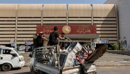 Followers of Iraqi cleric Moqtada al-Sadr carry their belongings on a pick up vehicle as they withdraw from the streets after violent clashes, outside the parliament at the Green Zone in Baghdad, Iraq, on August 30, 2022. REUTERS/Ahmed Saad