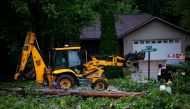 Fallen tree limbs are cleared after thunderstorms and high winds downed power lines and closed roads in Holland, Michigan, on August 29, 2022. Cody Scanlan/USA Today Network via REUTERS. 