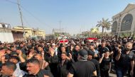 Mourners carry the coffins of fighters from Sadr's Peace Brigades, who were killed during clashes among rival Shiite Muslim militants in Basra, Iraq, on September 1, 2022. REUTERS/Mohammed Aty