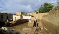 An Afghan man cleans up his damaged home after the heavy flood in the Khushi district of Logar, Afghanistan, August 21, 2022. REUTERS/Stringer

