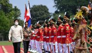 Indonesian President Joko Widodo walks with Philippine President Ferdinand 