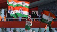 A supporter waves a flag of India's main opposition Congress party at a massive rally organised by the party against inflation, at Ramlila Ground, in New Delhi, on September 4, 2022. REUTERS/Anushree Fadnavis