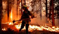 Firefighter Stephanie Endsley battles flames from the Mosquito Fire as it burns in Foresthill in Placer County, California, U.S., September 7, 2022. REUTERS/Fred Greaves