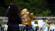 A woman pays respect outside the gate of Balmoral Castle, following the passing of Britain's Queen Elizabeth, in Balmoral, Scotland, Britain, September 9, 2022. REUTERS/Hannah McKay