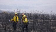 Firefighters look for hotspots in the black as the Fairview Fire smoulders near Hemet, California, on September 9, 2022. REUTERS/David Swanson