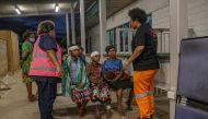 People are attended to while being evacuated following an earthquake, in Obura-Wonenara, Papua New Guinea, September 11, 2022. Manolos Aviation/Handout via Reuters