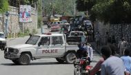Haitian National Police officers keep watch during a protest demanding the resignation of Prime Minister Ariel Henry, in Port-au-Prince, Haiti, on September 11, 2022. REUTERS/Ralph Tedy Erol