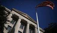 An American flag waves outside the US Department of Justice Building in Washington, on December 2, 2020.  File Photo / Reuters
