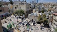 Rescuers search for survivors under the rubble of a collapsed building in Amman, Jordan September 14, 2022. REUTERS/Muath Freij/File Photo