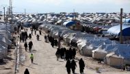 Women walk through al-Hol displacement camp in Hasaka governorate, Syria, on April 1, 2019.  File Photo / Reuters
