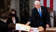 US Vice President Mike Pence hands the electoral certificate from the state of Arizona to US Senator Amy Klobuchar, Democrat of Minnesota, as he presides over a joint session of Congress to certify the 2020 election results on Capitol Hill in Washington on January 6, 2021. File Photo / Reuters
