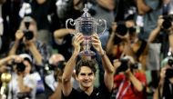Roger Federer of Switzerland holds up the trophy in front of photographers after winning his match against Novak Djokovic of Serbia in the men's final of the US Open in Flushing Meadows, New York, on September 9, 2007. File Photo / Reuters
