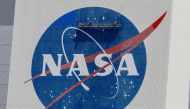 Workers pressure wash the logo of NASA on the Vehicle Assembly Building at the Kennedy Space Center in Cape Canaveral, Florida, US, on May 19, 2020. File Photo / Reuters
