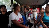 A group of partial hearing visitors communicate using sign language during a tour in an enclosed plain at the Cuba's national zoo in Havana, Cuba, September 21, 2022. REUTERS/Alexandre Meneghini