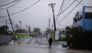 A man wades through a flooded street after Hurricane Fiona affected the area in Yauco, Puerto Rico September 18, 2022. REUTERS/Ricardo Arduengo/File Photo